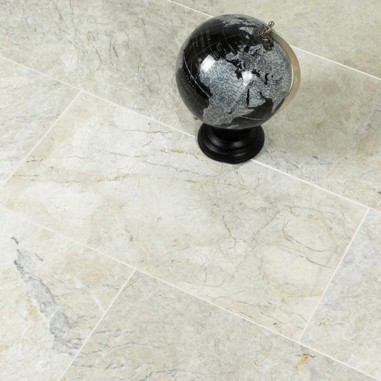 Why is it important to seal natural stone tiles?